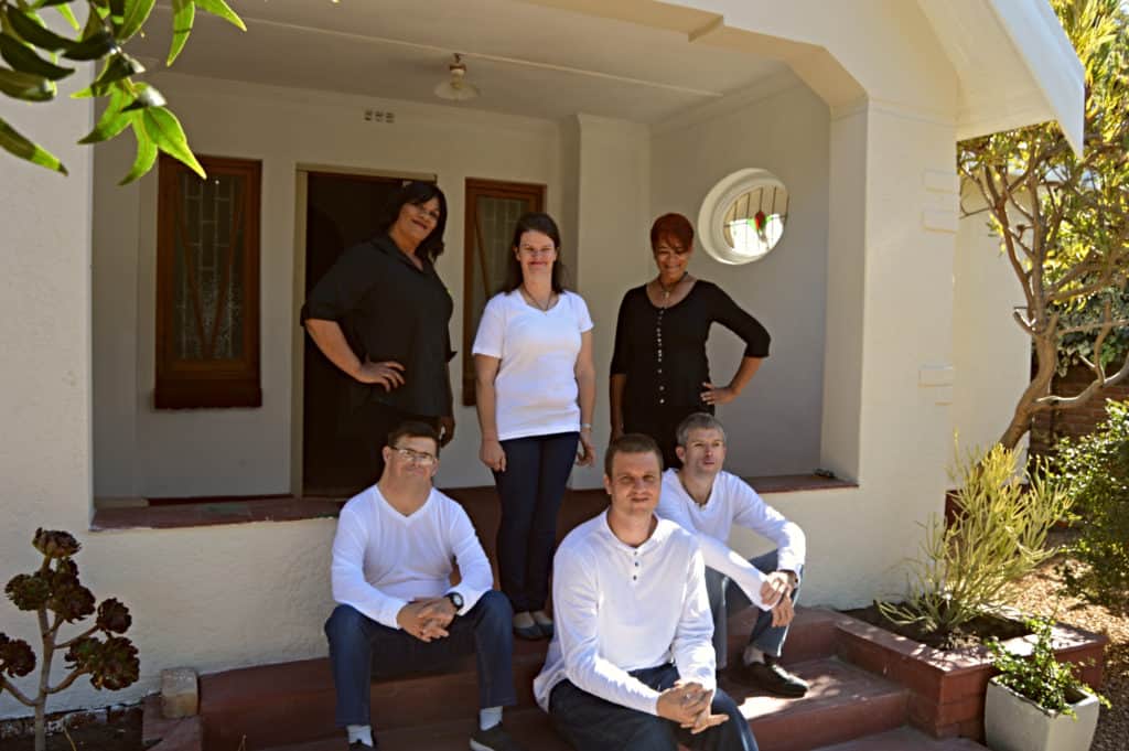 Group photo of the team in front of the house